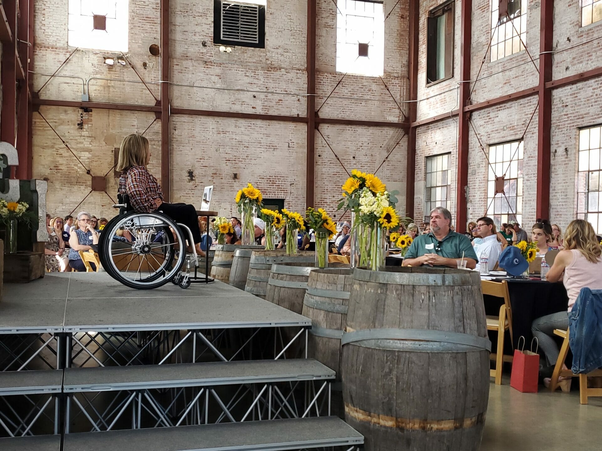 alycia on stage giving speech to pacific charter institute