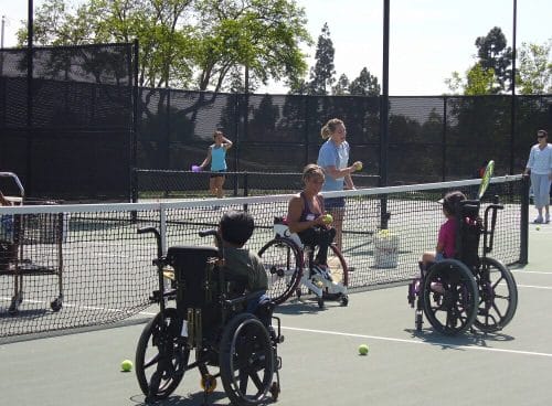 alycia teaching a wheelchair tennis clinic with juniors