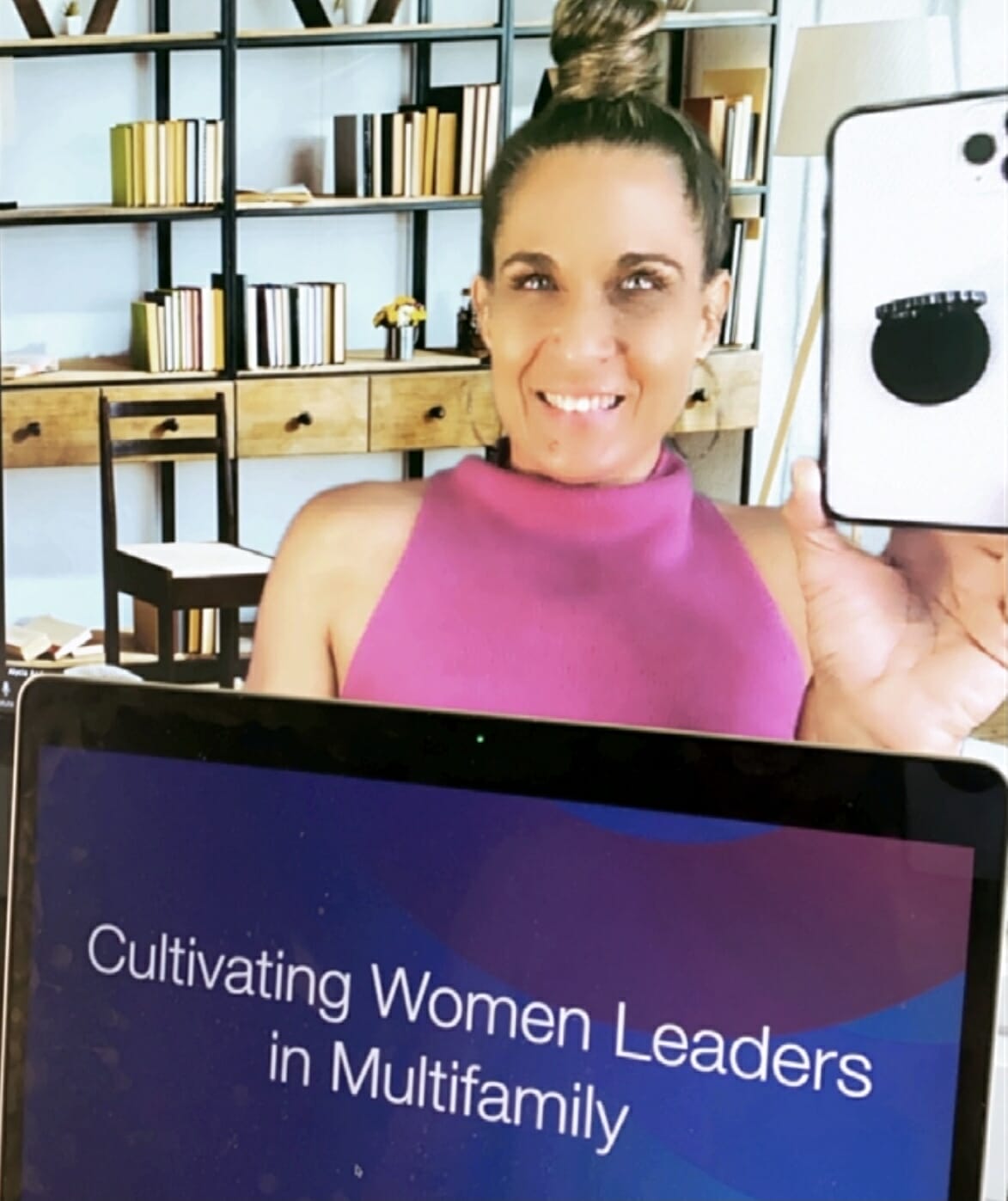 alycia above a laptop displaying cultivating women leaders in multifamily