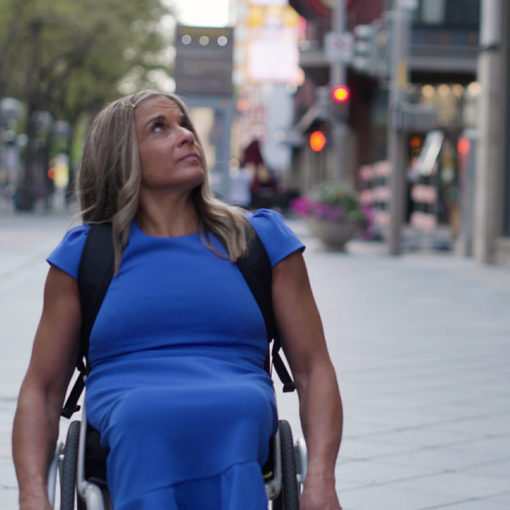 alycia looking up at the buildings on the streets of denver