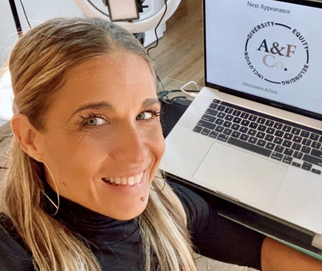 alycia smiling with her laptop displaying her next appearance at albercrombie and fitch