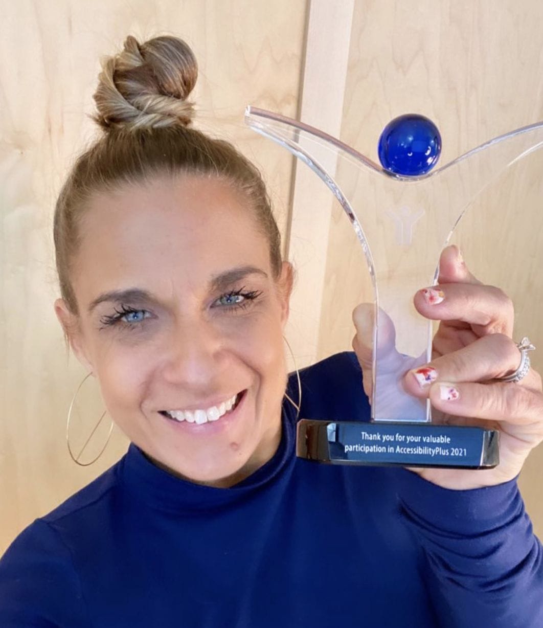 alycia holding her appreciation trophy from accessibility plus 2021