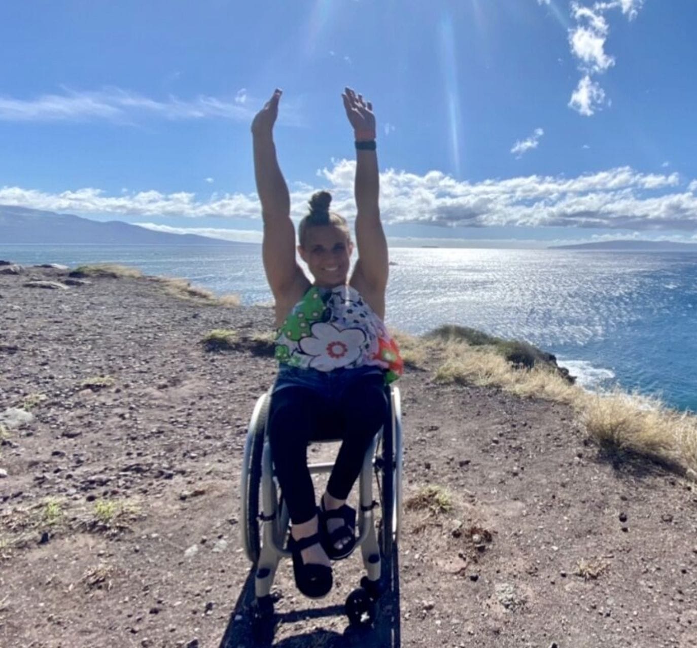 alycia at ocean lifting her hands over her head