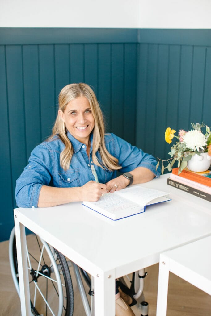alycia sitting at desk writing in notebook smiling