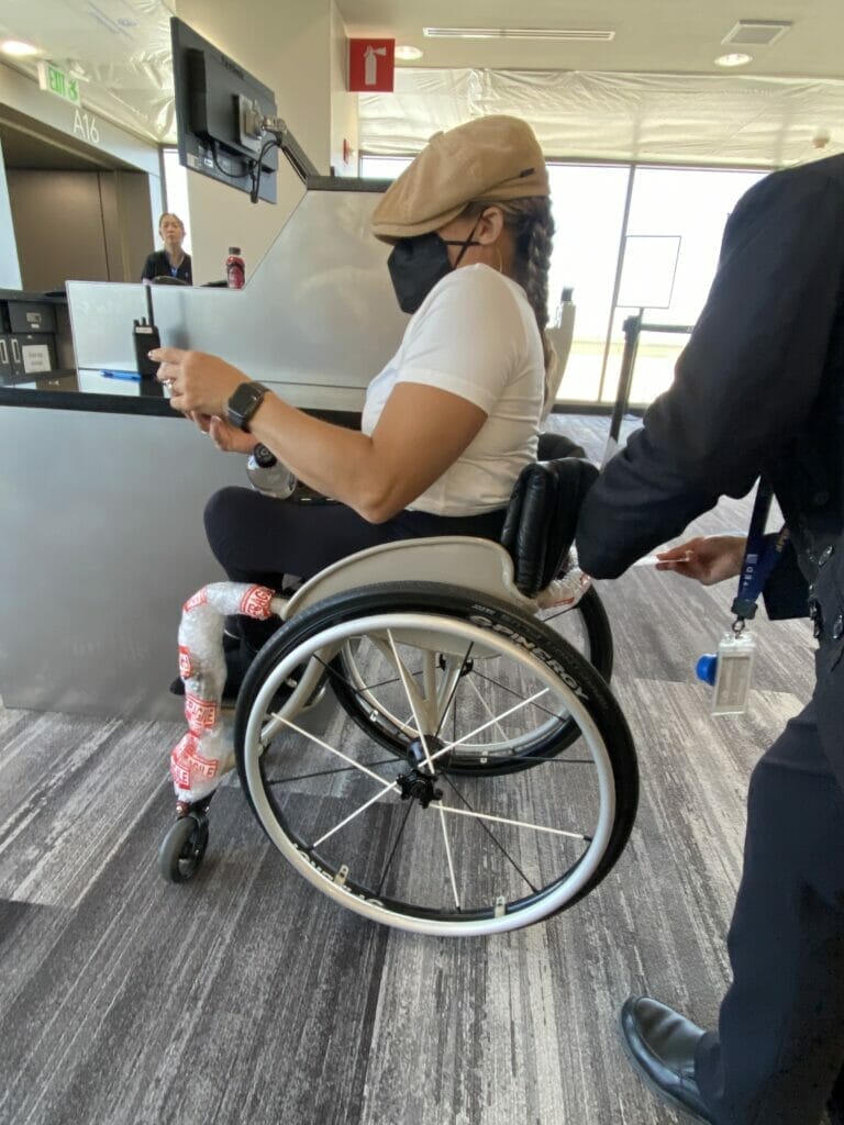 alycia having her wheelchair tagged at gate before boarding a plane