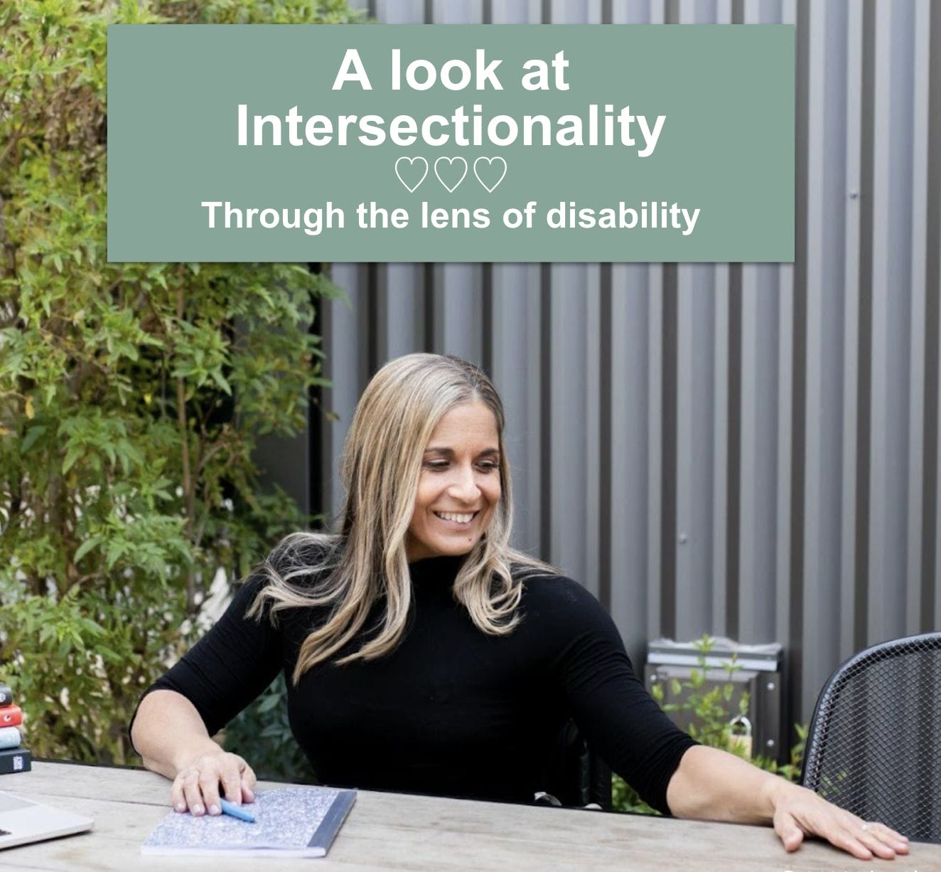 picture of alycia sitting at table welcoming with an empty chair heading above her says a look at intersectionality through the lens of disability