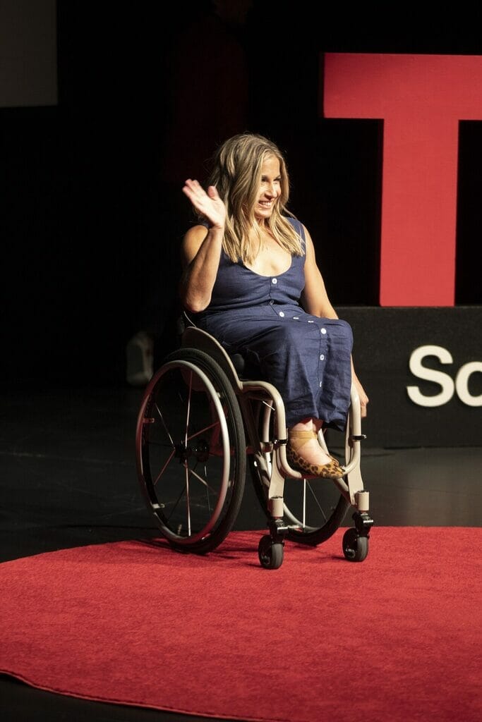 alycia waving to crowd as she comes out onto the red dot at tedx