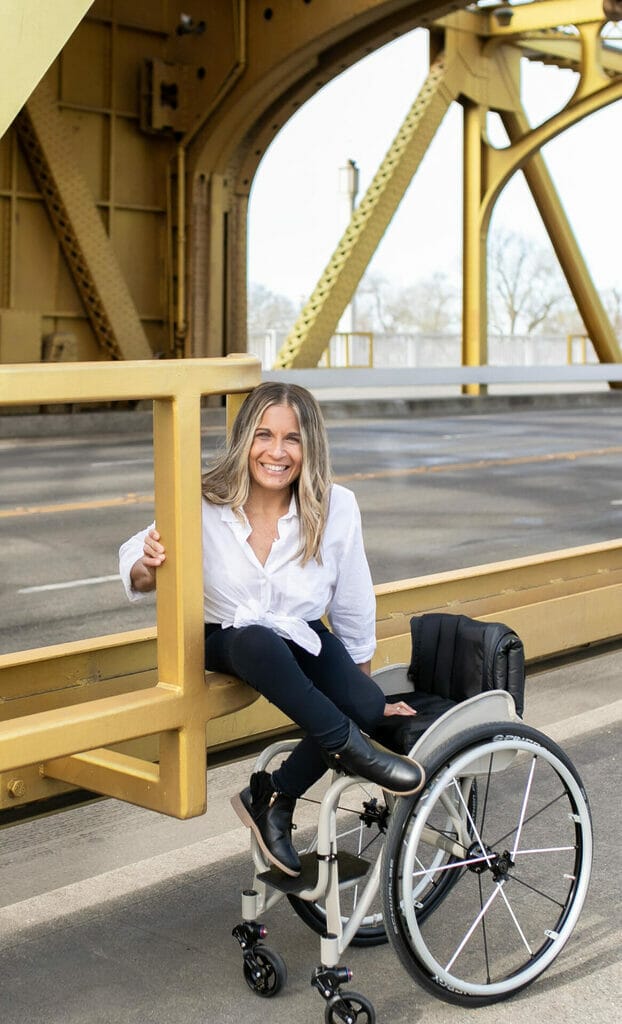 alycia sitting on a bridge