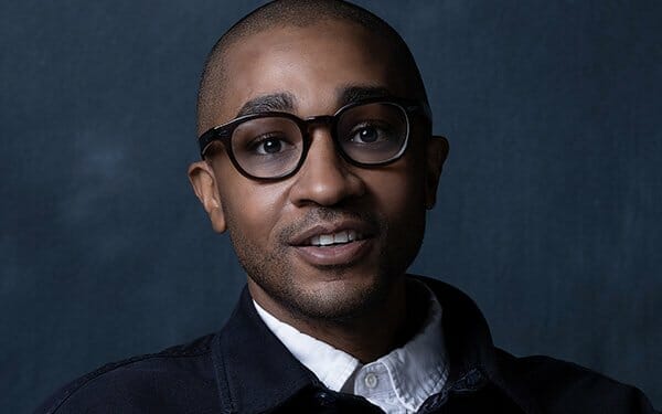 michael tennant wearing glasses and a jacket with a collared shirt