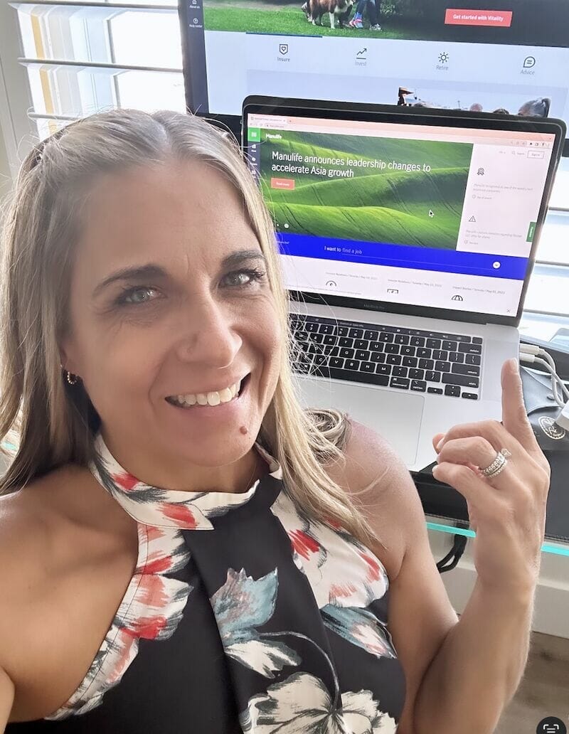 Alycia wearing blue sitting in studio giving a keynote pointing at the screen