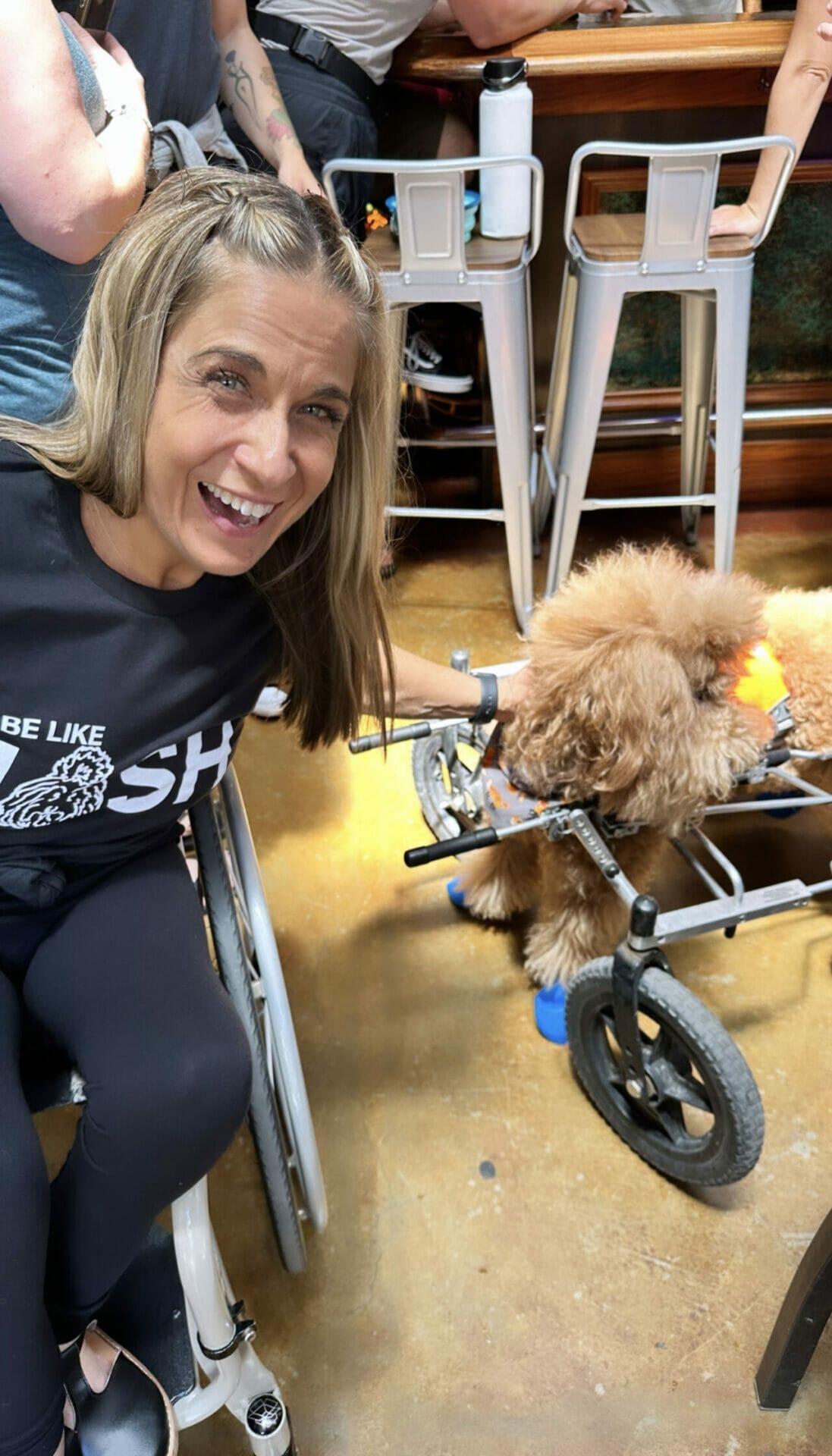 Alycia smiling with Josh in his wheelchair