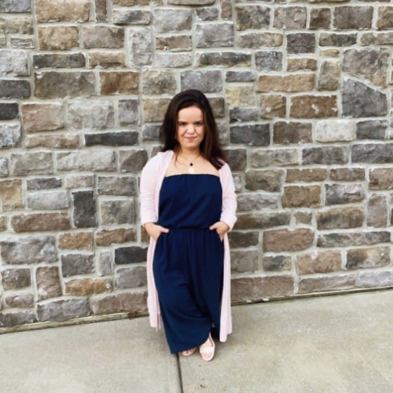 jillian curwin standing against a brick wall