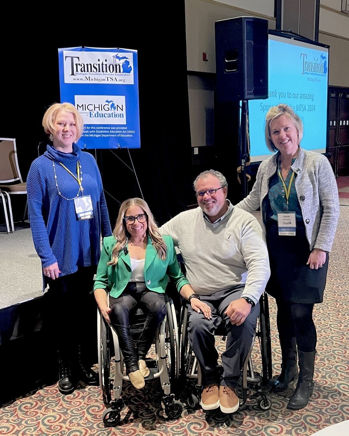 alycia and marty sitting with the organizers of the conference