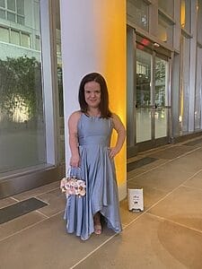 jillian curwin in a gown holding a purse