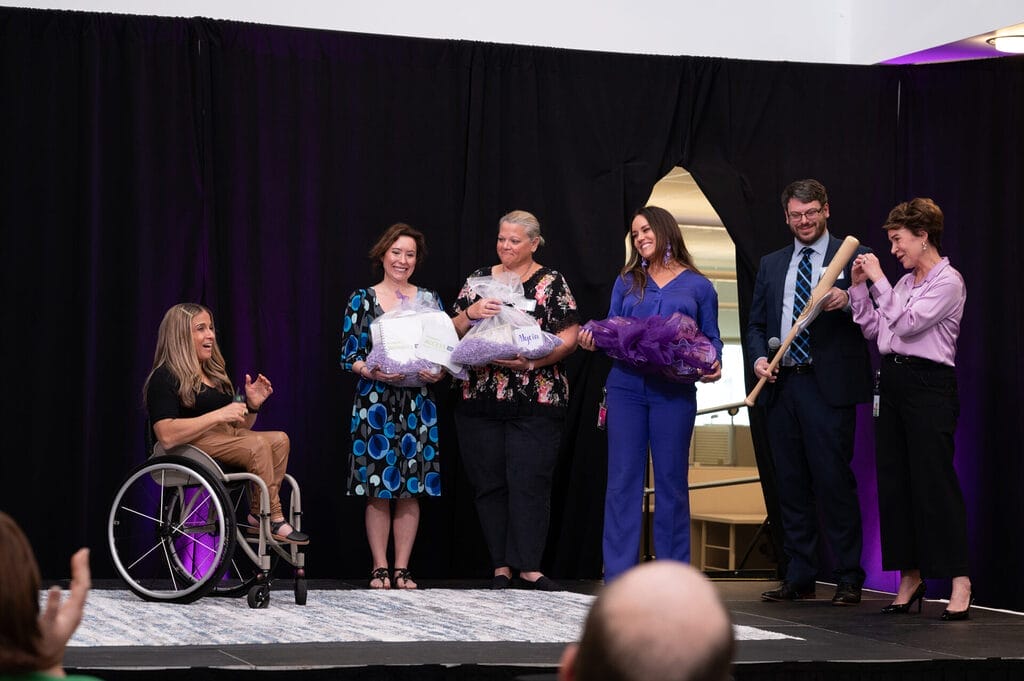 humana employees showering alycia with gifts on stage after her speech