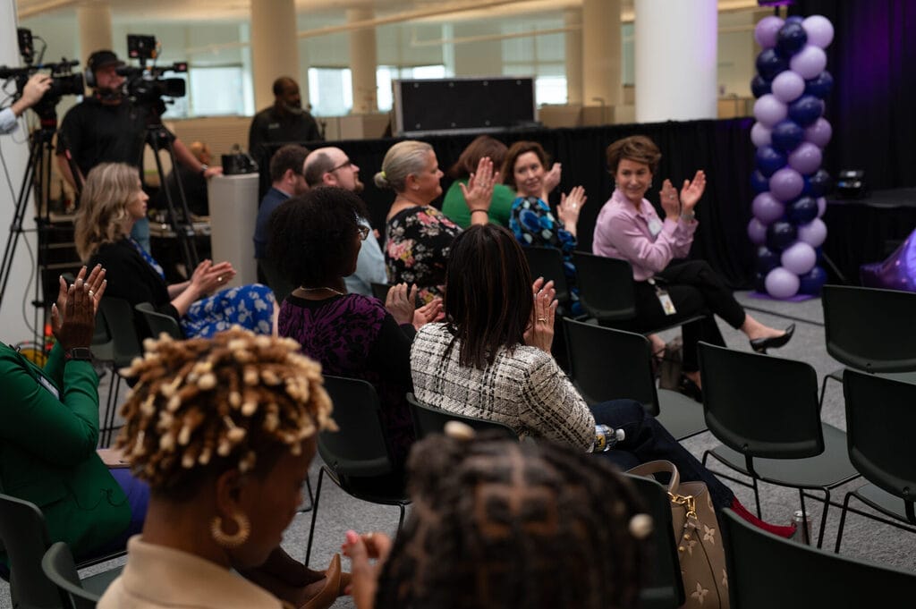 the in person crowd cheering for alycia with audio video cameramen in the shot