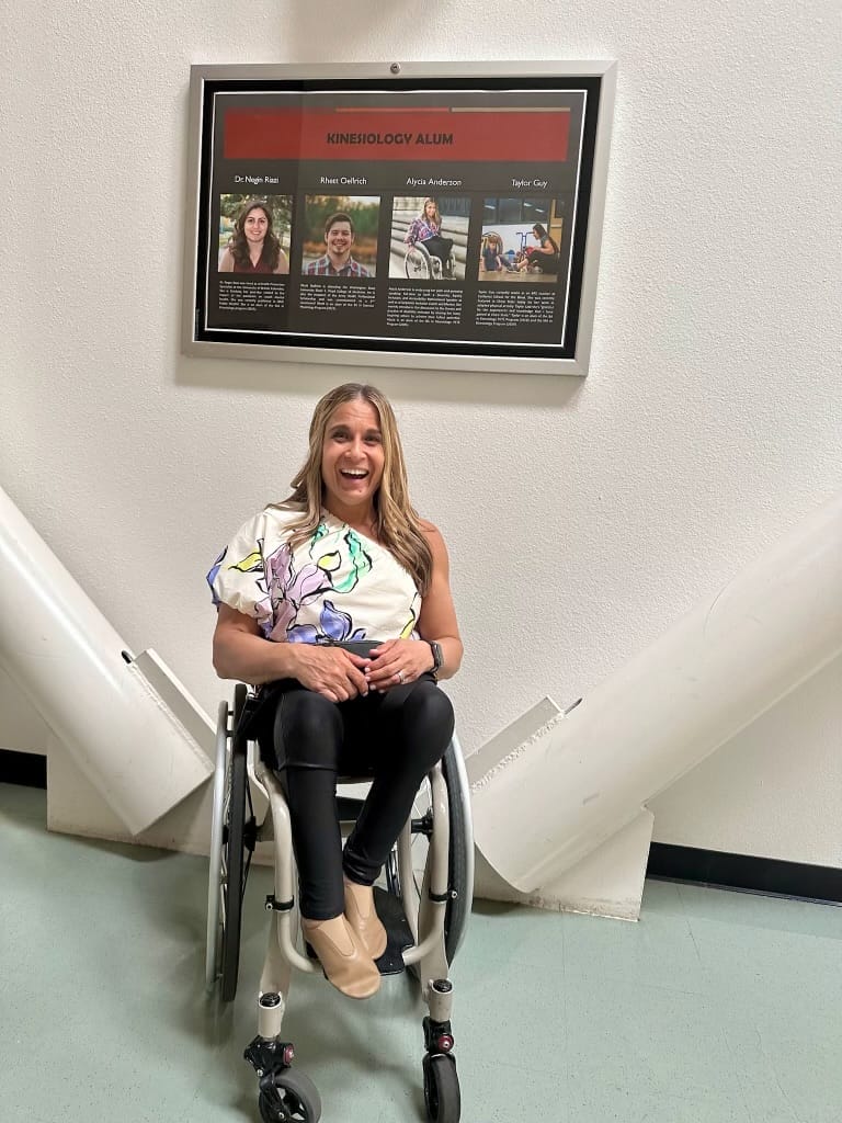 alycia smiling under a display in yolo hall with her picture and bio listed with other impactful graduates of the a p e program