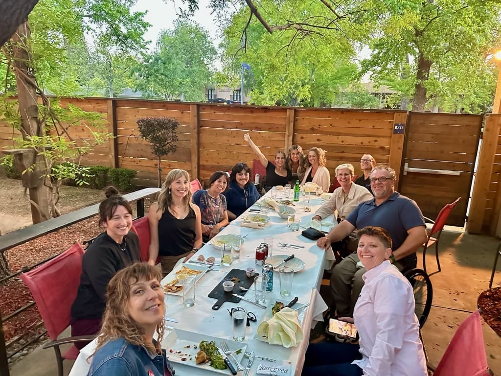 alycia sitting at her awards dinner with dean angelina tredethway