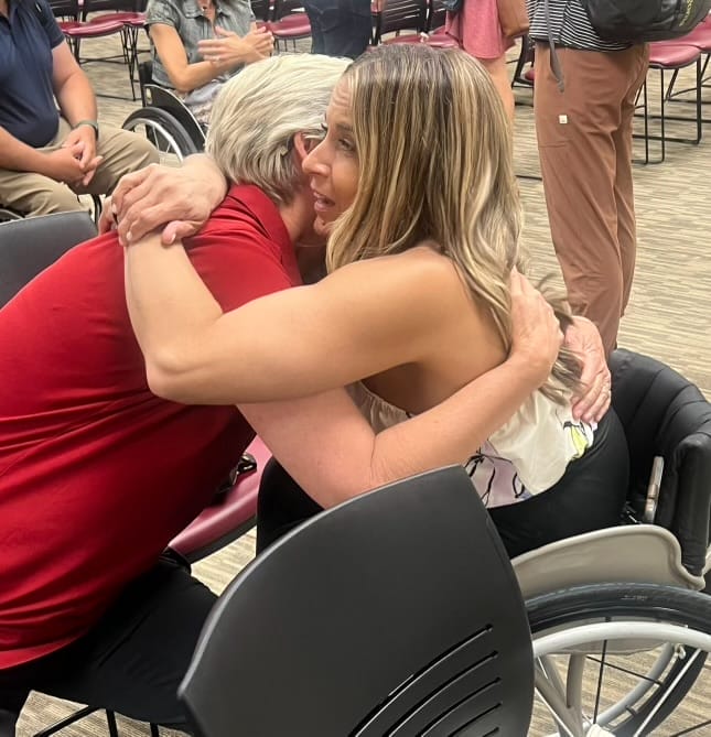 alycia hugging doctor lytle after speaking
