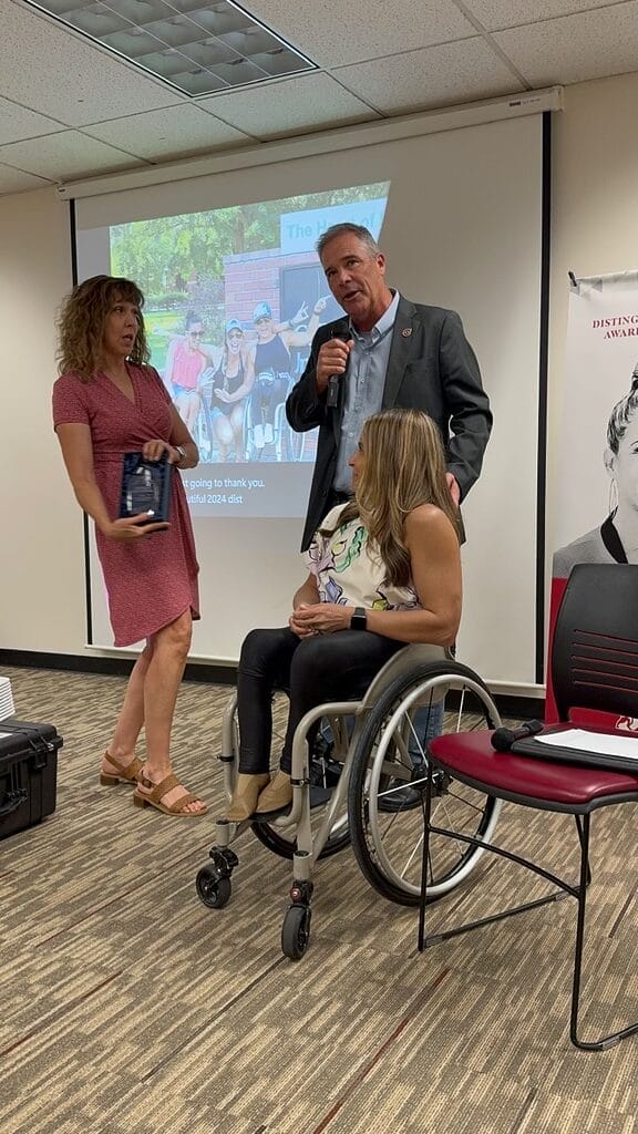 dean angelina tredethway and president stephen perez honoring alycia with the distinguished alumni award