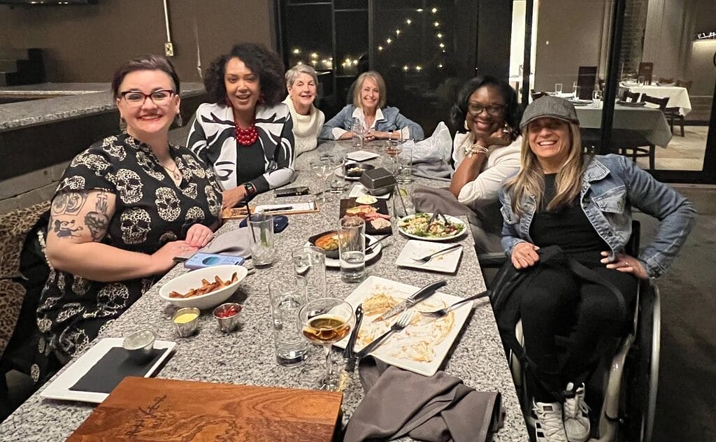 alycia at a restaurant table with the d e i team from humana