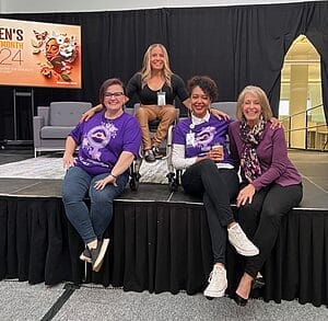 alycia on stage at tech check before speech at humana with ladies from the d e i team