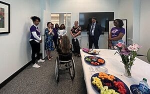 alycia in her see me green room talking with humana employees who have come to meet her before her speech