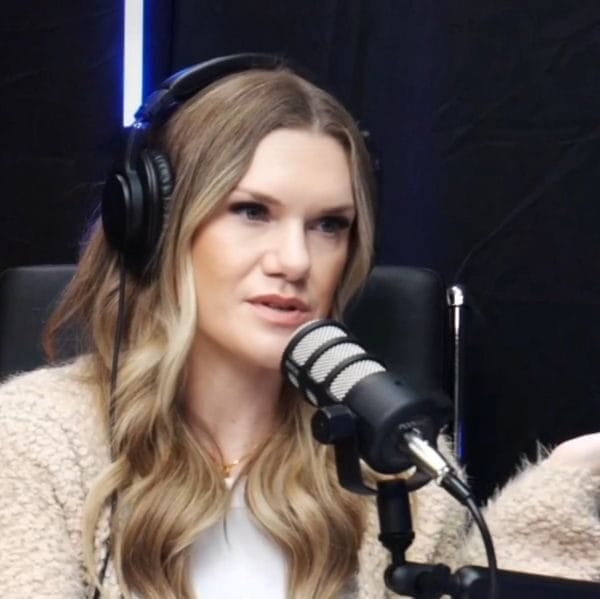 kimberly daya sitting with her headphones on in front of a microphone