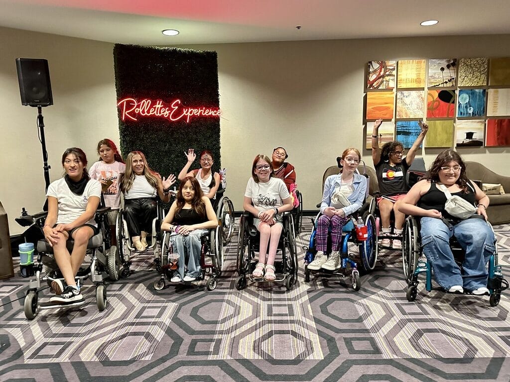 alycia taking a photo with teens at the rollettes experience