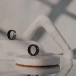 two wearable lotus rings sitting atop chunks of marble