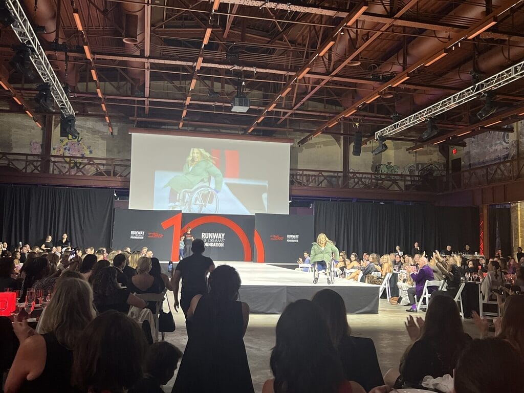 alycia on the runway during the live event at the runway of dreams