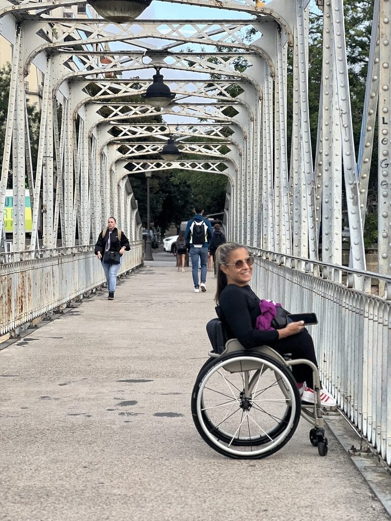 alycia sitting on a bridge over the canal san martin in paris