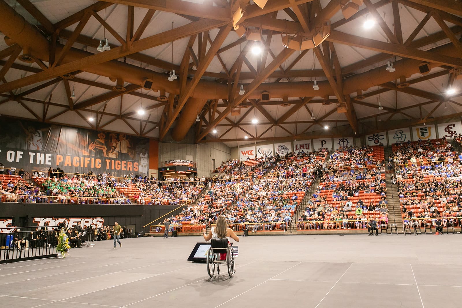 alycia on stage in a large stadium speaking to the crowd