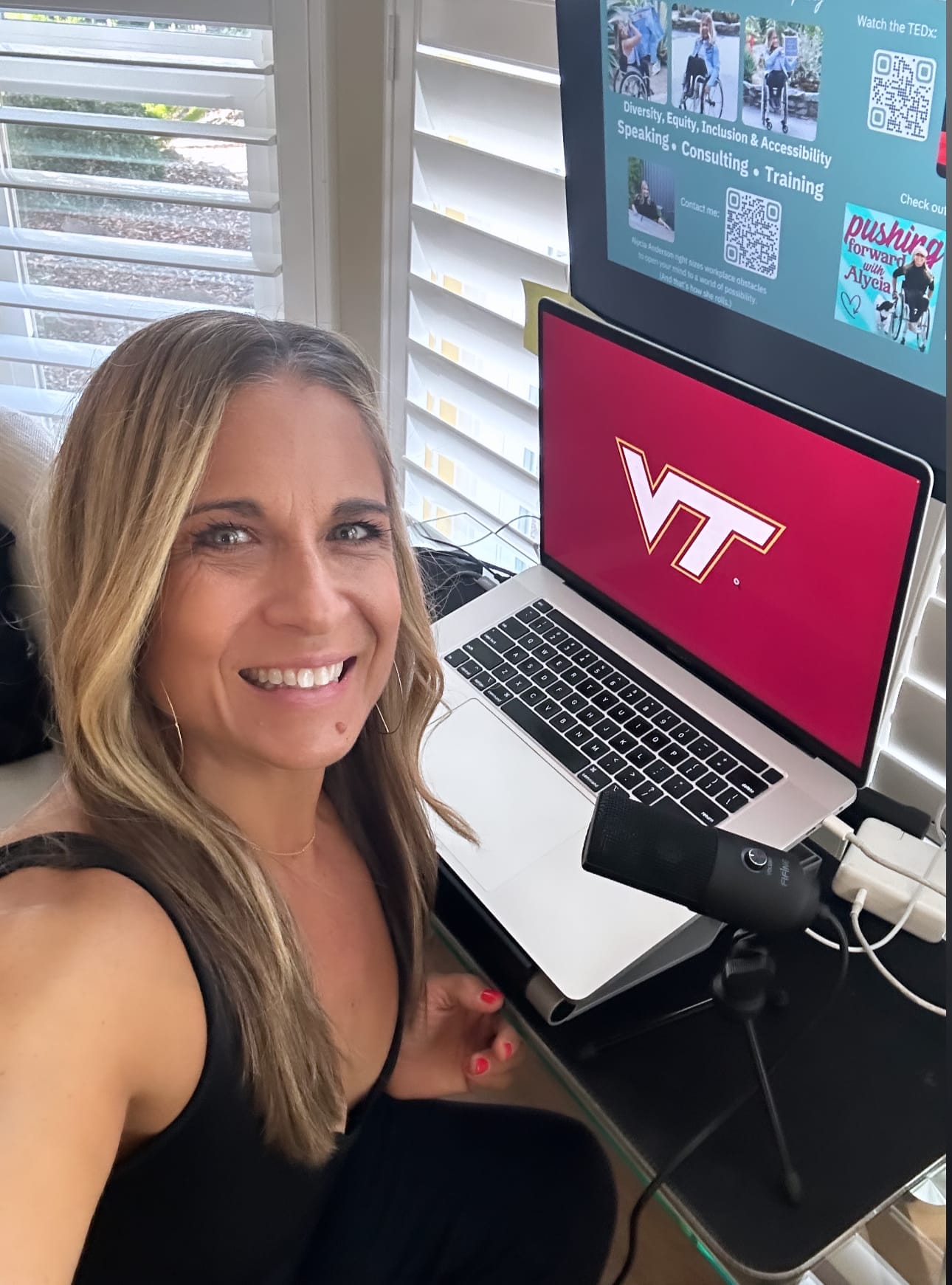 Alycia sitting in studio near microphone for keynote speech at VT