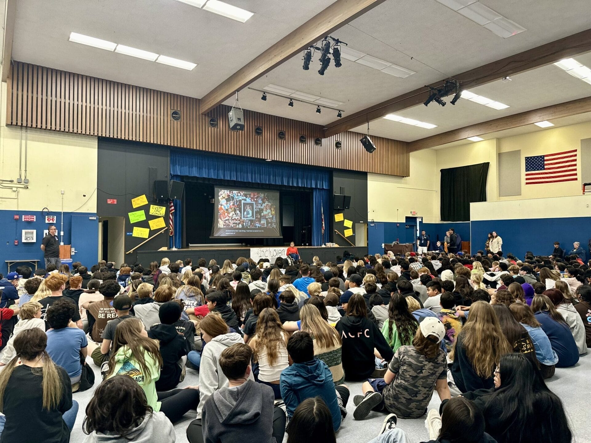 Alycia speaking in front of large group of students at sequoia middle school