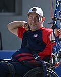 jason tabansky waering dark blue team usa gear after just releasing an arrow in his competition
