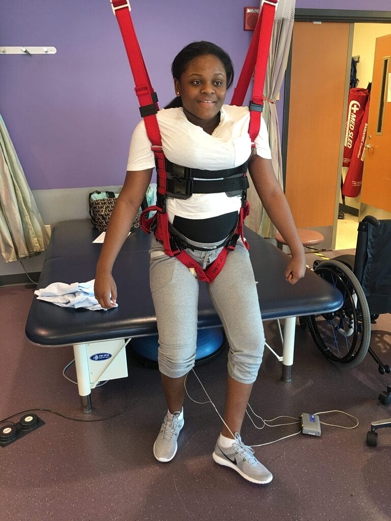 nevaeh on suspension harness while working in rehab