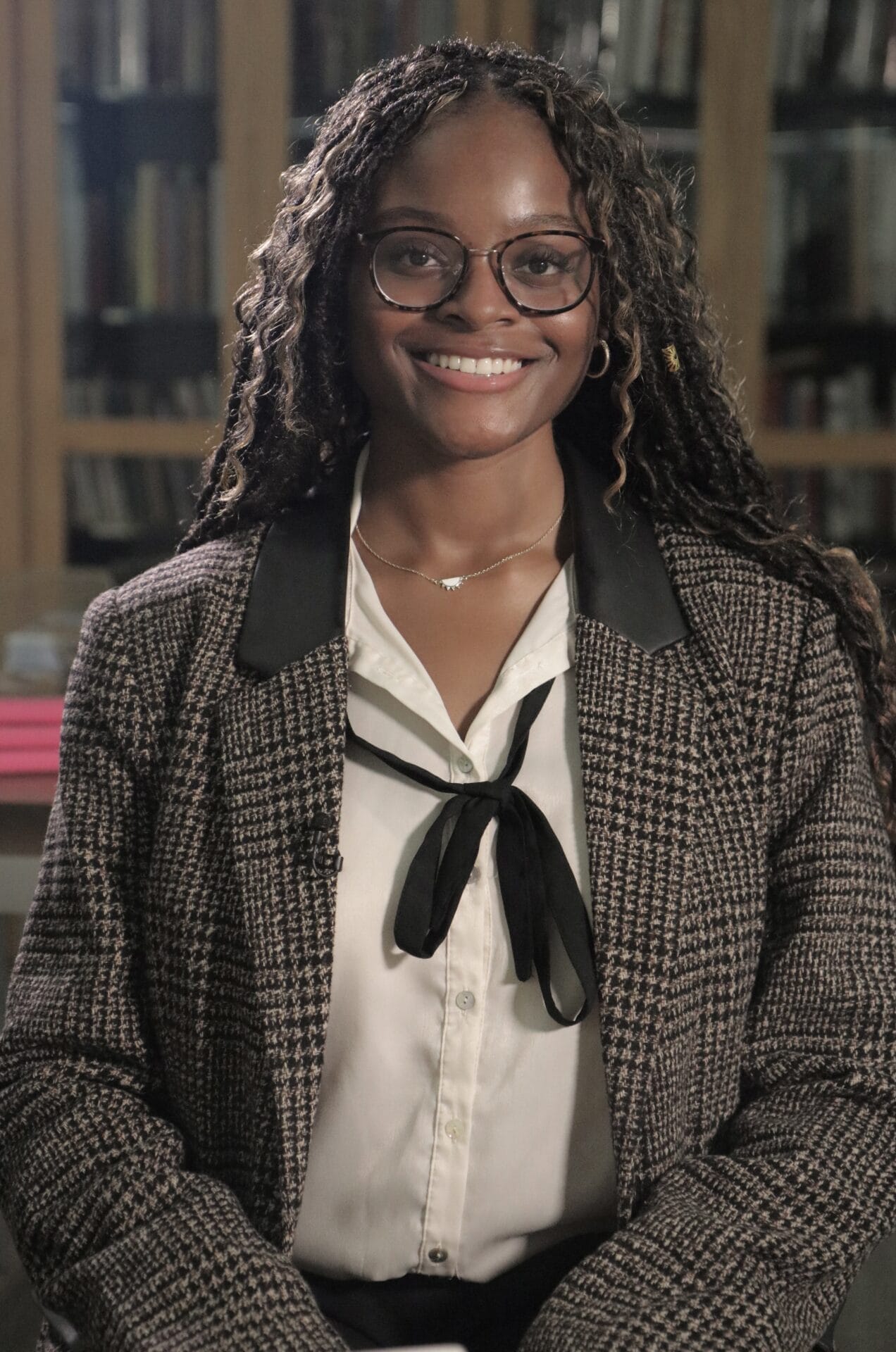 nevaeh as a senior at drexel university smiling wearing a professional ensemble with a black ribbon and blazer jacket