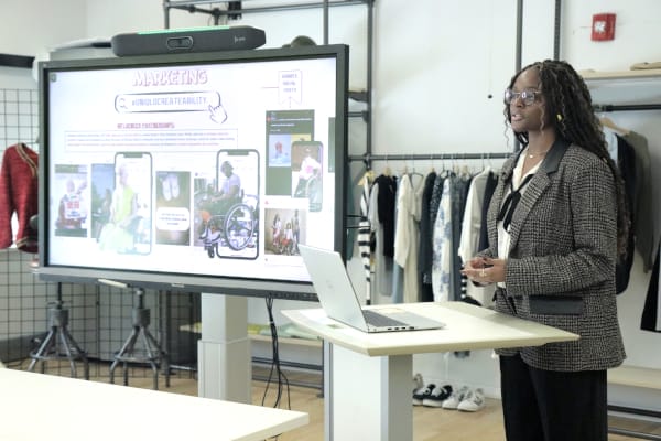 nevaeh delivering a presentation with a laptop and video display monitor