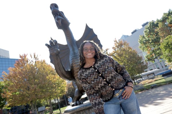 nevaeh in front of dragon statue