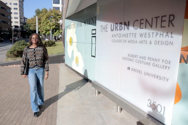 nevaeh walking next to the urbn center college of media and arts sign at drexel university
