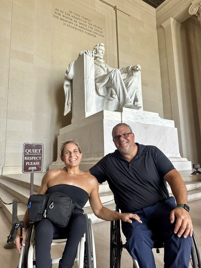 marty and alycia sitting in front of lincoln statue inside the lincoln memorial