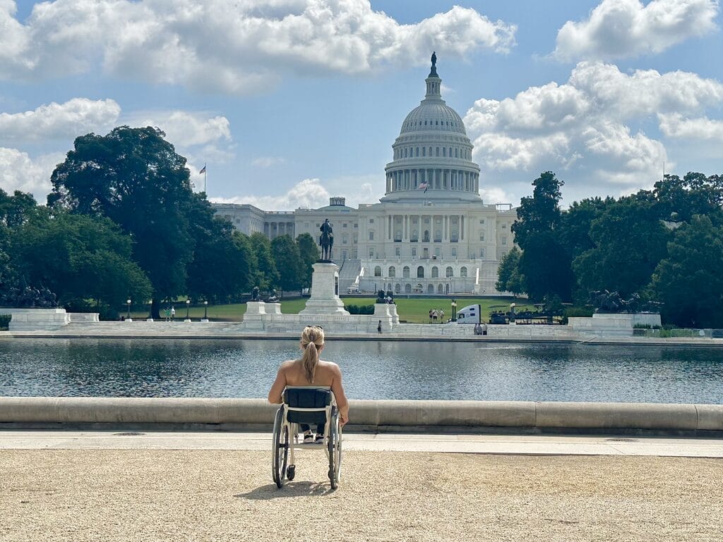 alycia sitting in her wheelchair facing the capitol with her back to the camera