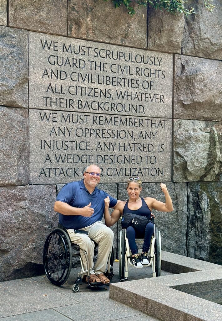 marty and alycia sitting in front of quote at fdr memorial