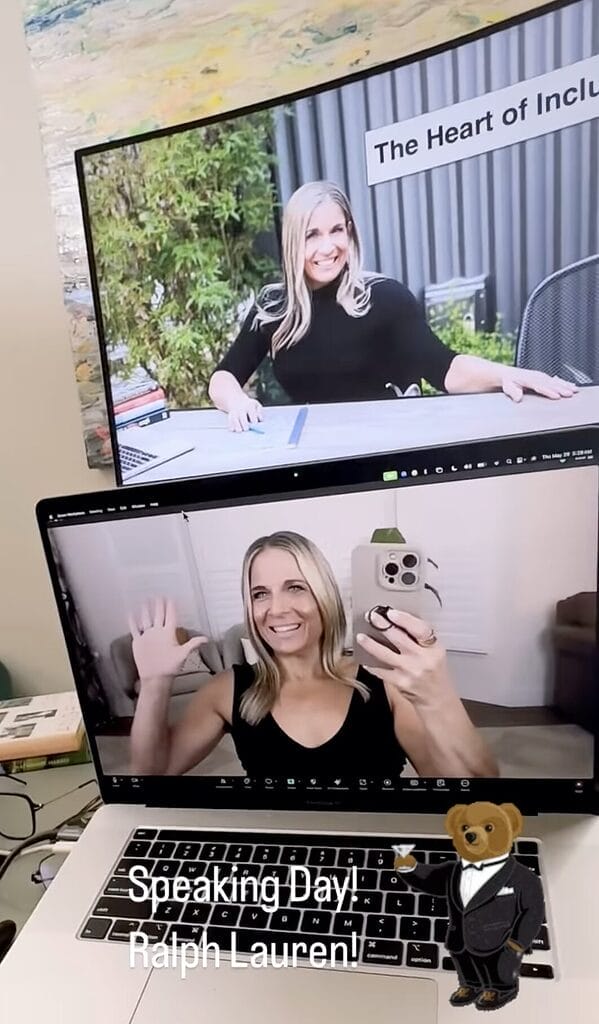 Alycia in selfie video wearing black on her studio in front of two screens giving a keynote.
