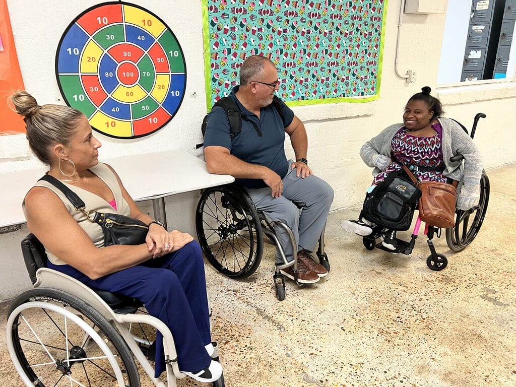 alycia and marty touring frost industries speaking with megan a young lady who also uses a wheelchair