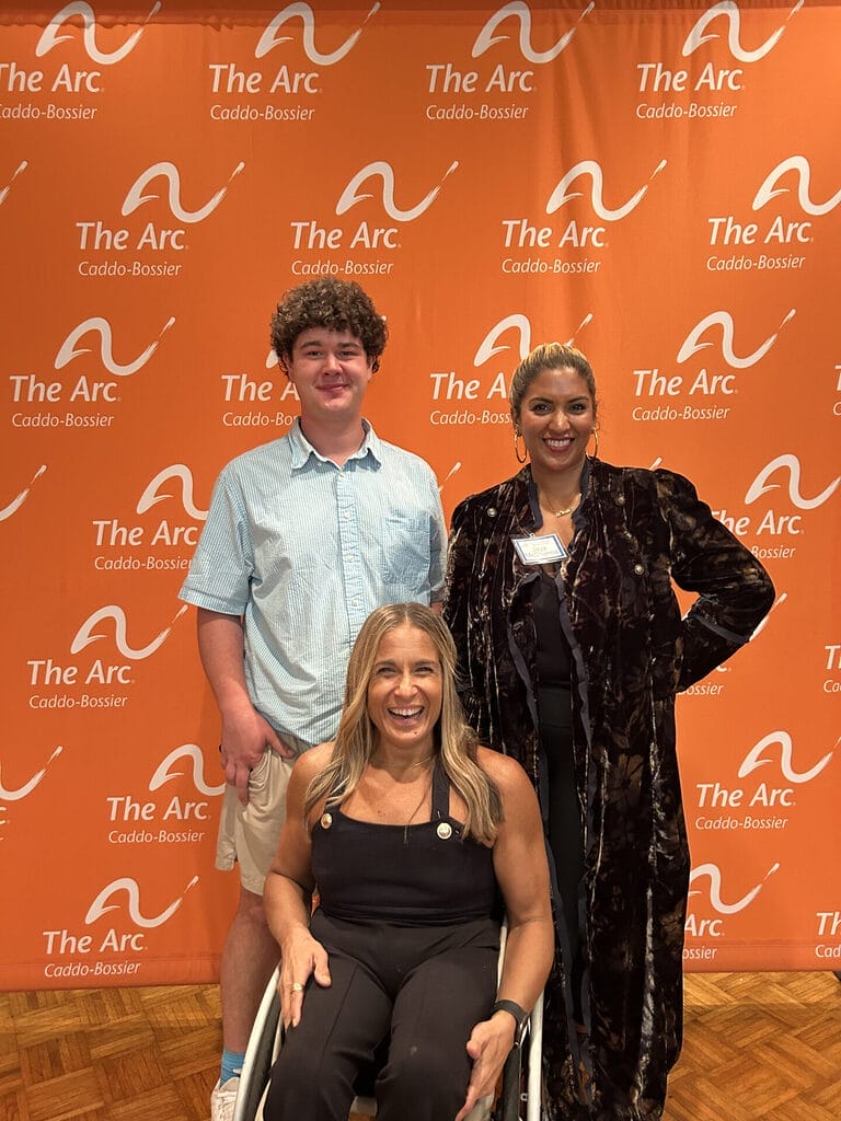 alycia posing for a picture with doctor jaya and a young man who attended the luncheon