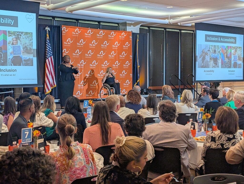 alycia on stage at the arc caddo bossier leadership luncheon on l s u s campus