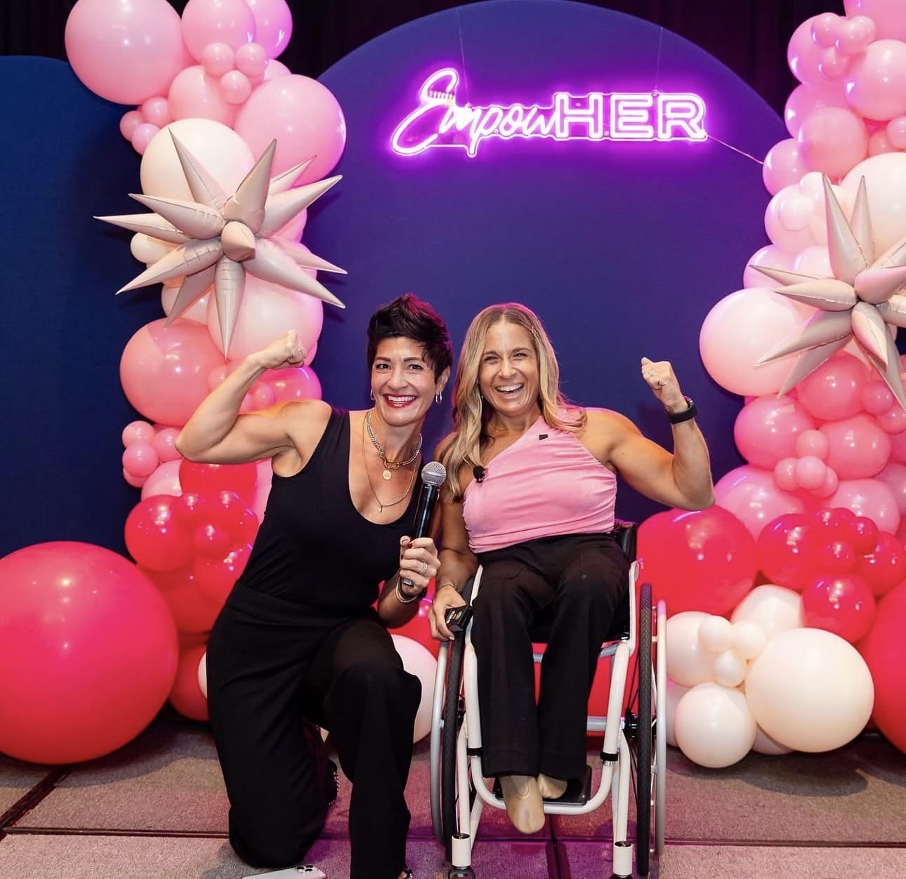 Alycia and Kristina host of event taking a photo flexing