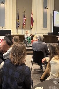 alycia on stage speaking at the center for disability awards luncheon